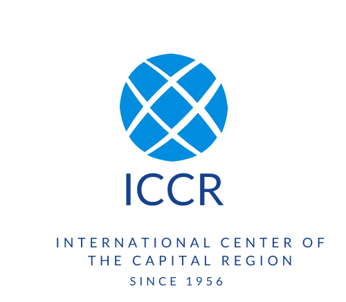 A blue and white logo of the international center of the capital region.